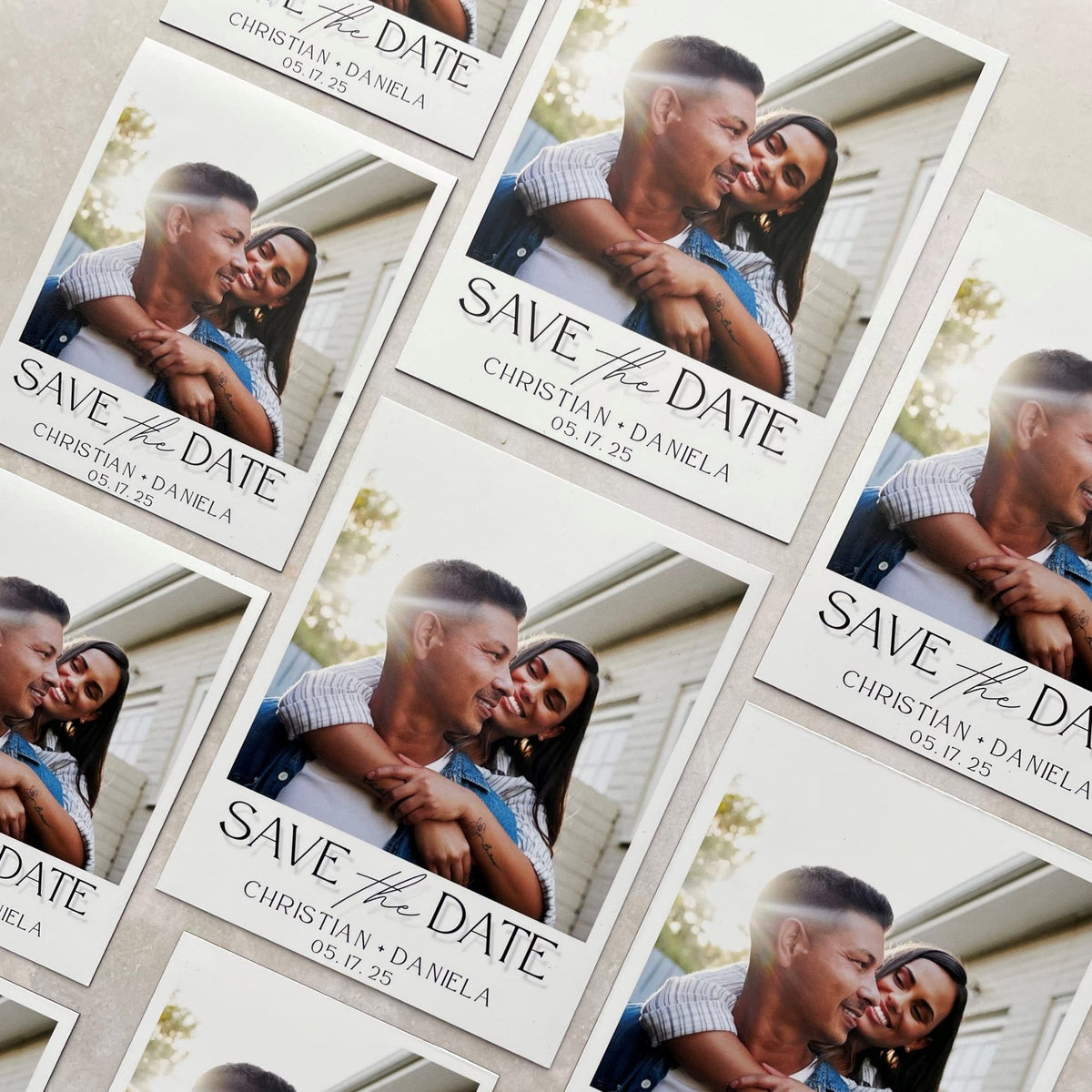 Custom save the date invitation magnet with engagement photo and wedding date, styled on a table with flowers and wedding planning accessories.